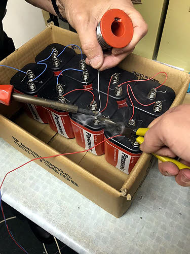 Soldering up a set of token batteries